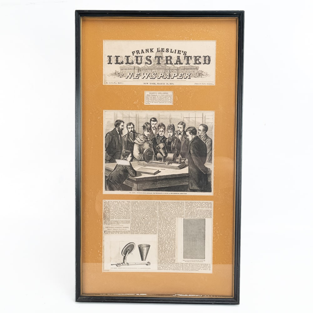 1878 Phonograph Invention Announcement: Framed and matted Frank Leslie's Illustrated Newspaper article about "Professor" Edison's new invention, The Phonograph. Includes the front page banner, an engraving showing Edison demonstrating his