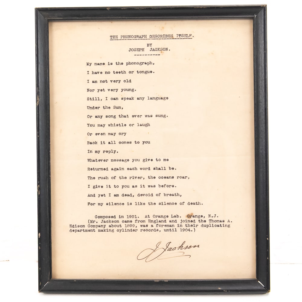 The Phonograph Describes Itself Poem: Framed typed poem titled, ”The Phonograph Describes Itself” by Joseph Jackson. At the bottom of the page it says that the poem was composed in 1901 at the Orange Lab. In Orange N.J. and