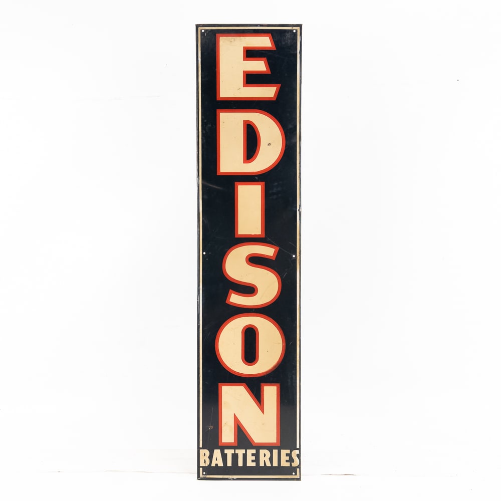 Edison Batteries Tin Advertising Sign: Single-sided tin litho, rolled edge vertical sign for Edison Batteries. In overall VG condition with a few small scratches and a small edge wrinkle to the left of the I. Measures Mounting holes all th