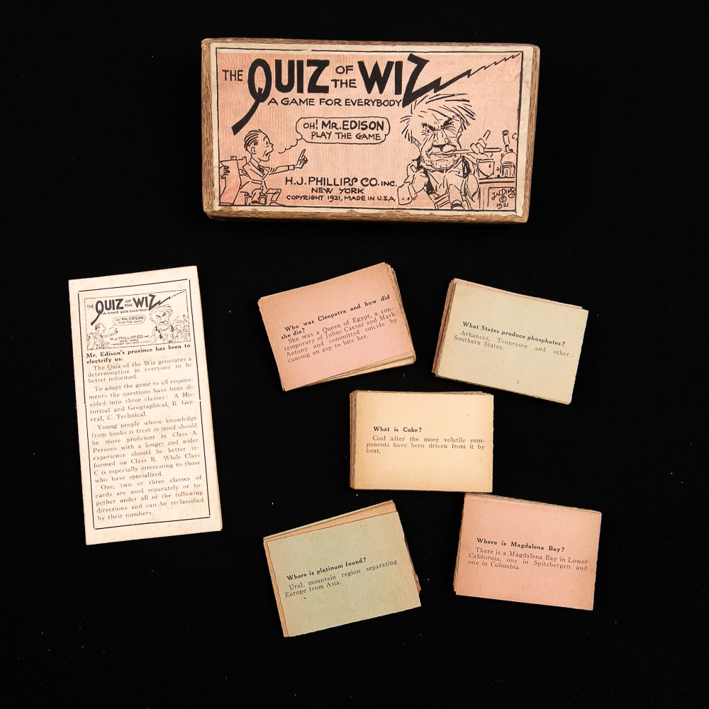 Edison Quiz of the Wiz Game: The Quiz of the Wiz is an antique parlor trivia game released in 1921 by the H.J. Phillips Co. of NYC. Inspired by a 1921 political cartoon that featured Thomas Edison on the cover, it contains miniat