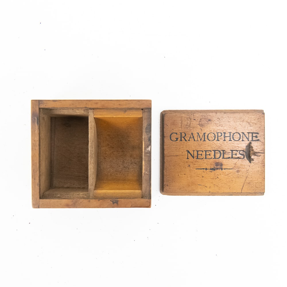 Original Wooden Gramophone Needle Box: Very early and desirable two-piece wooden gramophone needle storage box. Original cover top is plainly marked gramophone needles. Has its original varnish finish; a rare accessory. See photos for