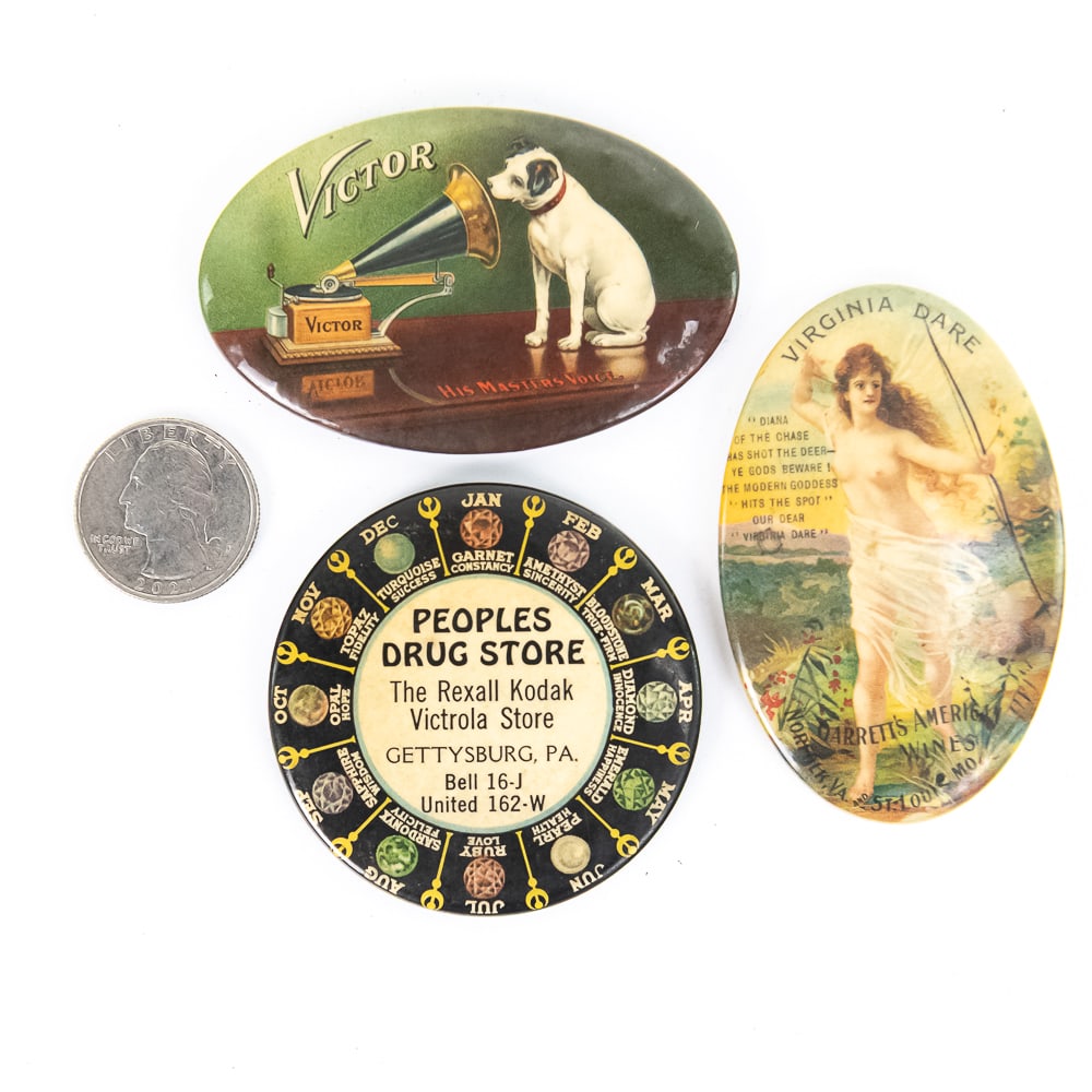 3 Vintage Advertising Pocket Mirrors: Includes a Peoples Drug Store in Gettysburg PA selling Victrolas, a His Master's Voice Victor trademark, and a Virginia Dare Wine naked lady. All in good condition. From the Allen Koenigsberg