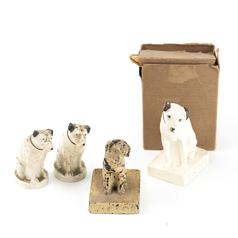 Victor Nipper Dog Advertising Group (4 Pc): An exceptional assembly of early 20th-century advertising memorabilia featuring Nipper, the iconic mascot for the Victor Talking Machine Company. This lot features a pair of ceramic salt and pepper sh