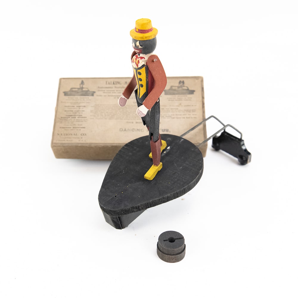 Original Dancing Rastus Phonograph Toy: Rare accessory featuring its original two-piece cardboard box with instructions on the top. The mechanism and dancing doll (black figure which dances to the music) appear to be complete, possibly unus