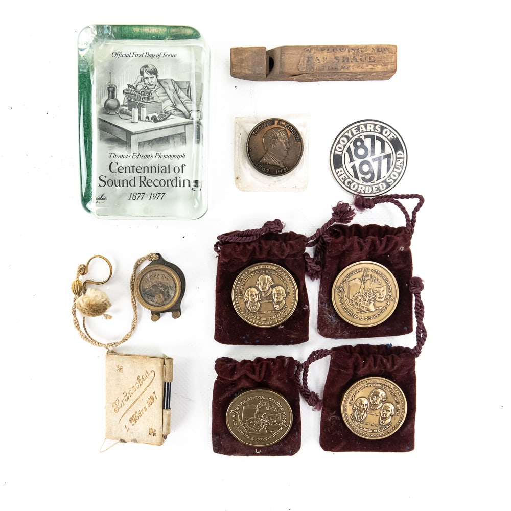 Nine-Piece Lot of Advertising and Commemorative Me: Interesting lot consisting of one Columbia phonograph advertising wooden whistle, one glass paperweight featuring Thomas Edison and the centennial of recorded sound (1877-1977), one very unusual