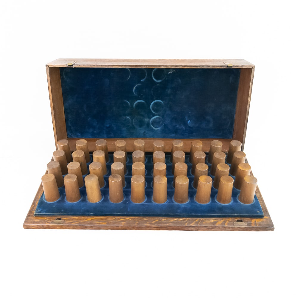 Oak Cylinder Record Storage Case: Solid oak hinged lid cylinder record storage / carrying case. Brass clip locks on the front. Lid opens to reveal 40 wood pegs with blue velvet inside lid and on bottom of the case. quarter sawn oak