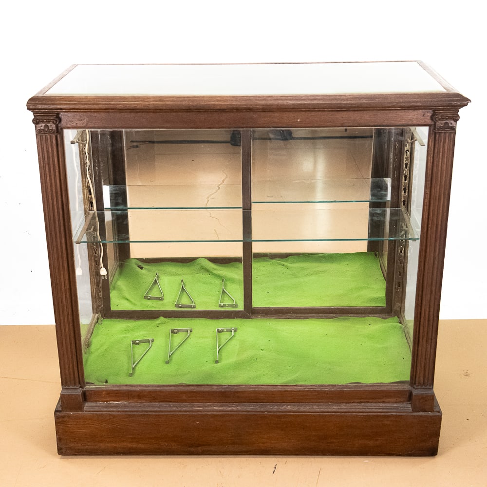 Glass Showcase: Smaller size vintage glass showcase found in general stores,candy stores, etc. Oak frame with wood sliding doors in rear, top and 3 sides glass. Comes with 2 glass shelves. Beveled glass top has multi