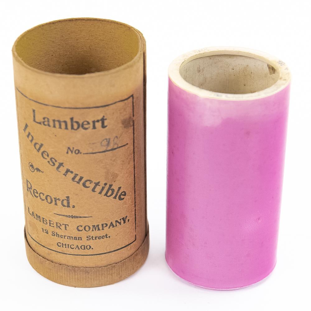 Pink Lambert Cylinder Record # 255: # 255 The Charlatan - March. Pink color is a little uneven at the title edge. Does not fit on the mandrel. Will need to be opened up a little bit. Has original box but no lid. From the Allen