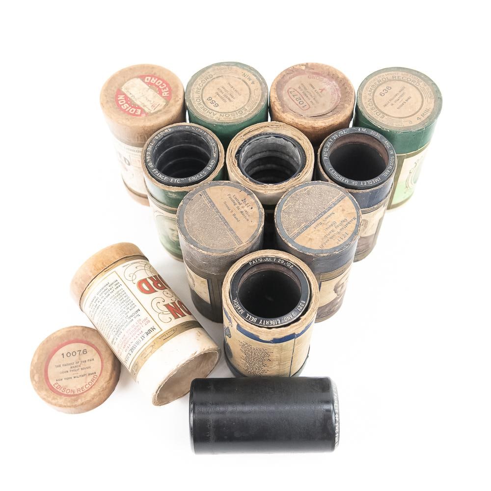 10 Edison & Indestructible Cylinder Records Sousa: Lot of 10 cylinders, some wax some celluloid of Sousa Marches. All in good condition in boxes, some with matching lids. Includes an additional black wax Sousa broken in the box with matching title lid