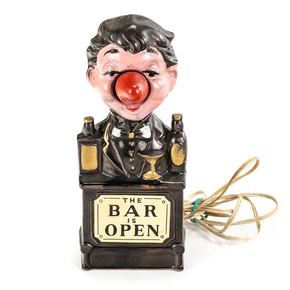 Vintage "The Bar is Open" Bartender Lamp: Vintage "The Bar is Open" Bartender Lamp, mid-century novelty item made of ceramic, depicts a humorous, tipsy bartender standing behind a bar counter flanked by liquor bottles, front plaque reads "The