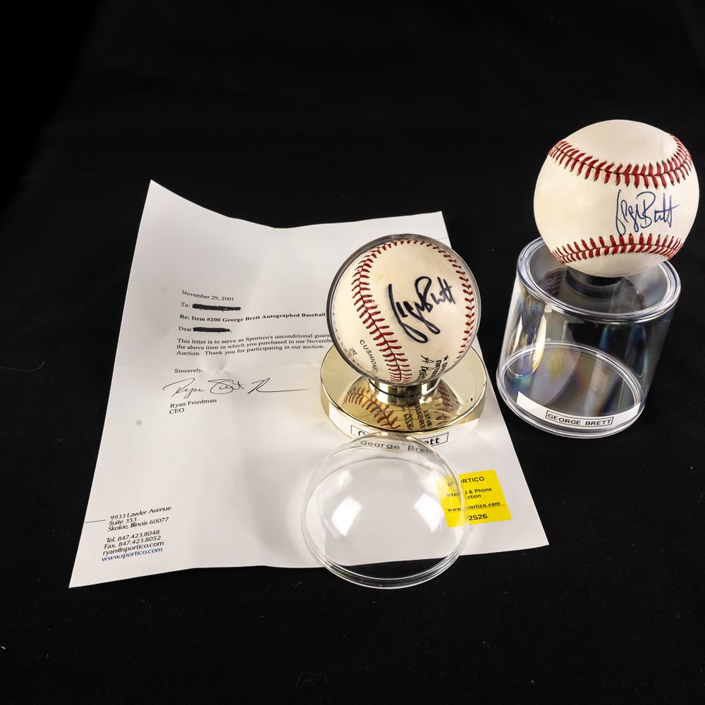 (2)George Brett Autographed MLB Baseballs w COA: PAIR of Kansas City Royal fan favorite & Hall of Fame inductee George Brett autographed Rawlings Official AL & NL League Baseballs with (1) Sportico LOA. Showcased inside protective acrylic display ca