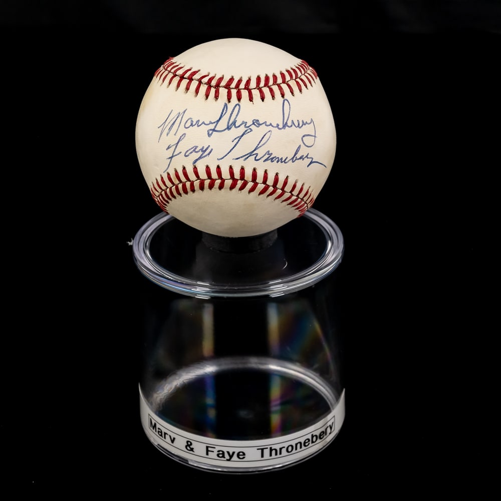 Marv & Faye Thronebery Autographed OAL Baseball: Marv & Faye Thronebery double autographed Rawlings Official American League MLB Baseball. Bold Blue ink double signature smack dab in the sweet spot !!! Showcased inside handsome acrylic display