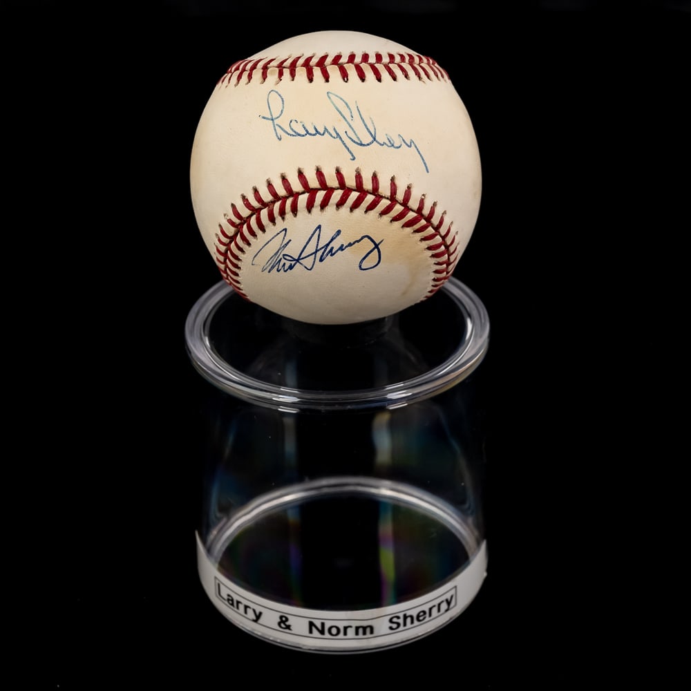 Larry & Norm Sherry Autographed ONL Baseball: Larry & Norm Sherry double autographed Rawlings Official American League MLB Baseball. Attractive Bold Blue ink double signature !!! Showcased inside handsome acrylic display cases. Perfect additions