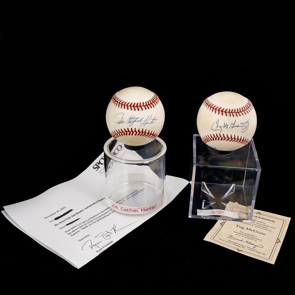 Jim Catfish Hunter & Tug McGraw Autographed Balls: Jim Catfish Hunter (LOA) & Tug McGraw (COA) autographed Rawlings Official American & National League MLB Baseballs. Bold Blue ink signatures smack dab in the sweet spots !!! Showcased inside handsome 