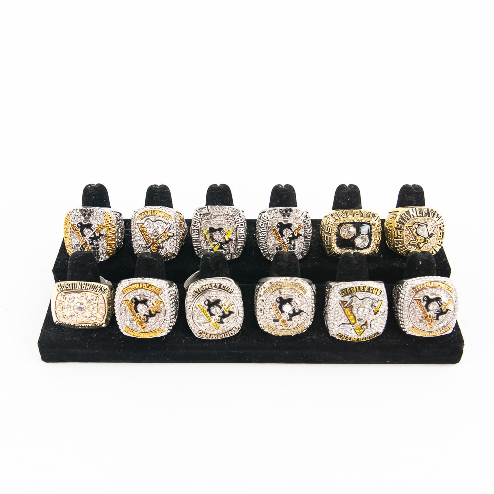 (12) Bruins & Penguins NHL Championship Rings: (12) Assorted Bruins & Penguins NHL "Championship Rings". Striking eye catching NHL replicas look identical to the REAL DEAL. Perfect addition to your collection, please use photos to judge condition 