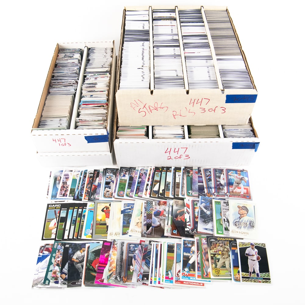 7k-10k MLB Baseball Card Assortment: Collection of 7k-10k assorted 2019-2025 MLB Baseball cards including some Rookies, All Stars, Refractors & Set builders. Showcased across (2) four row and a single double row card storage boxes. Lots 
