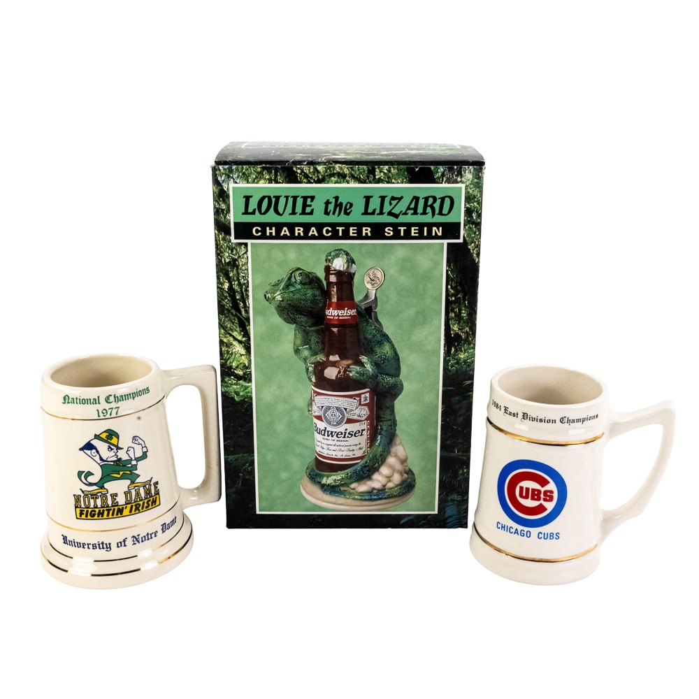 NIB Louie the Lizard Budweiser & Cubs ND Steins: Collection features NIB Louie the Lizard character beer stein with original packaging paired with Notre Dame & Chicago Cubs steins and vintage Jordan Wheaties box. From the Bobby O'Neill collection.