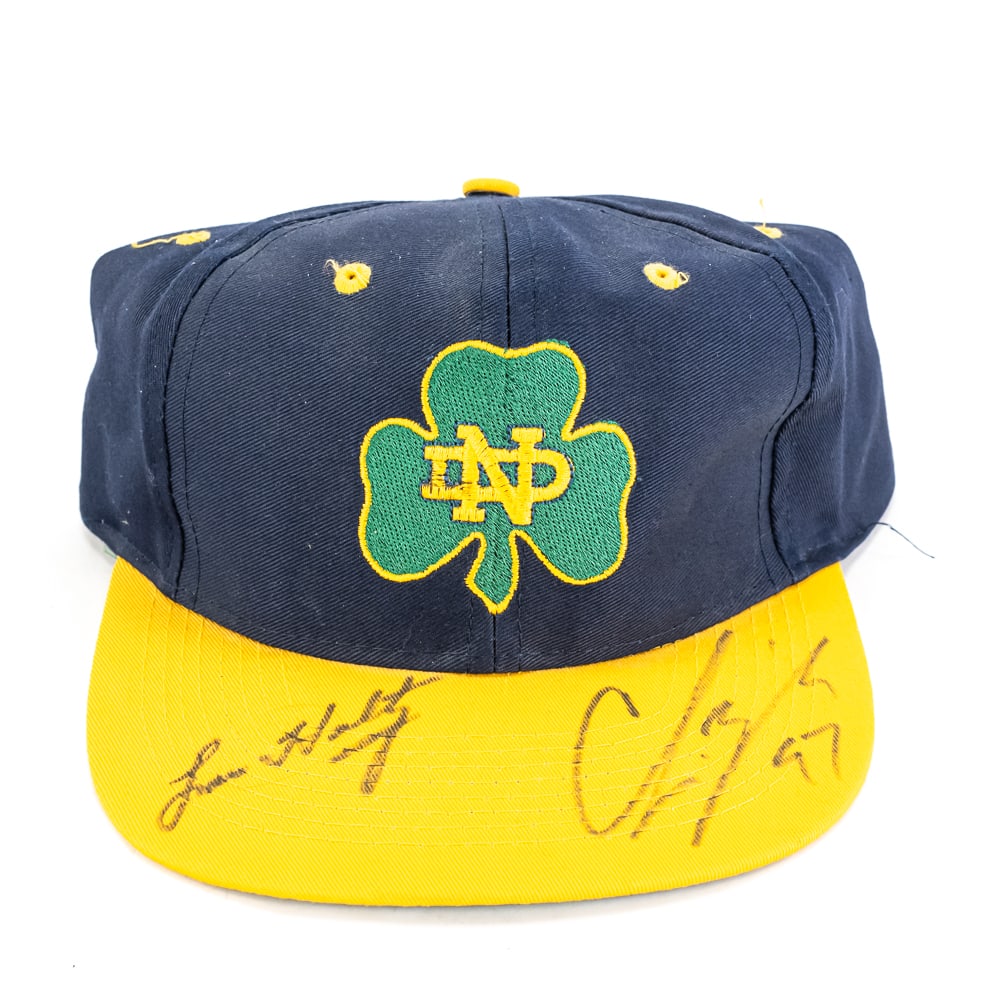 Notre Dame Legends Autographed Cap: Title: Notre Dame Legends Autographed CapCap Manufacturer: Competitor Sports – Officially Licensed by Notre DameCap Description: Navy Blue body with Gold bill and embroidered Shamrock on front