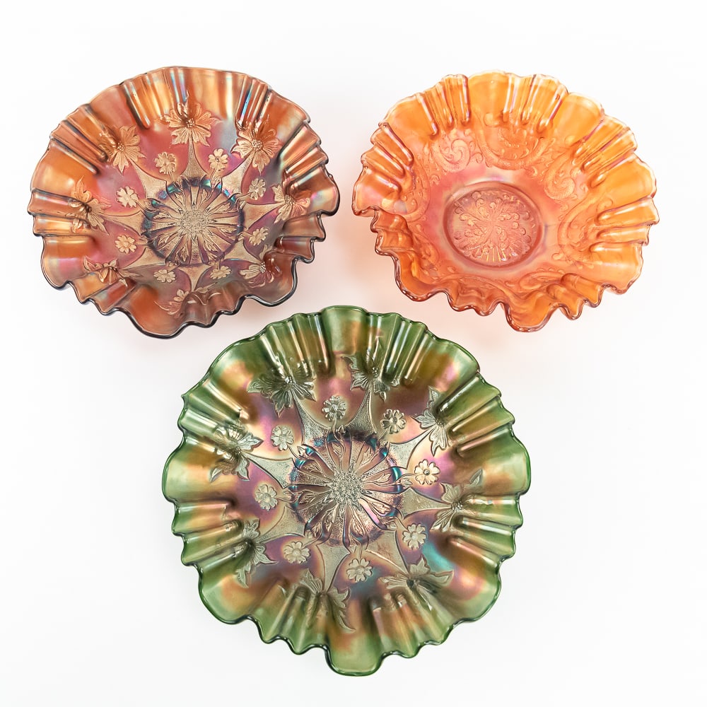 Carnival Glass: Fenton Bowls 3pc Lot: Includes a 10 in. amethyst Little Flowers bowl with a 3-in-1 edge, a matching 10 in. Little Flowers bowl in green, and a 10 in. Feathered Serpent bowl in marigold with a 3-in-1 edge. Very pretty iride