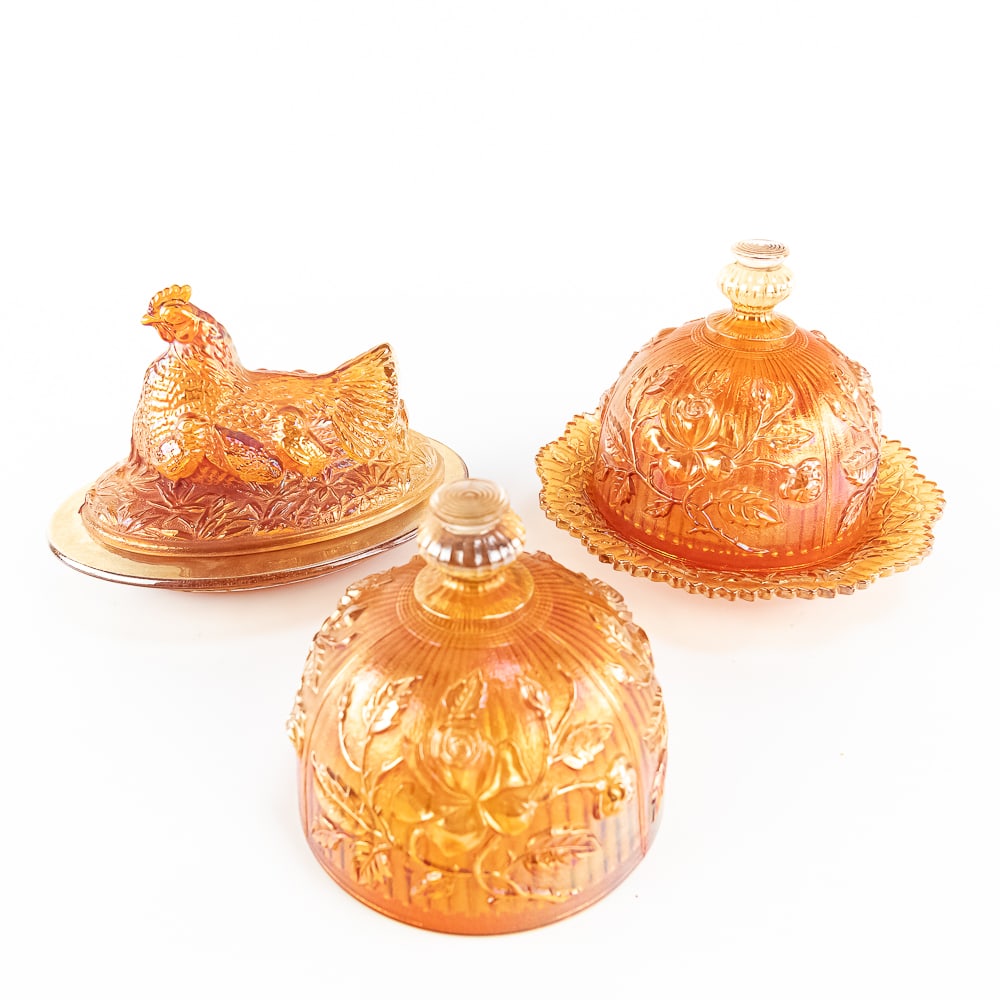 Carnival Glass Butter Dishes: 3-Pc Lot: Includes a Sowerby Hen on Nest in marigold (very good condition, nice iridescence), an Imperial Luster Rose covered butter dish (chips on base teeth, large crack inside base, lid is perfect), and an e