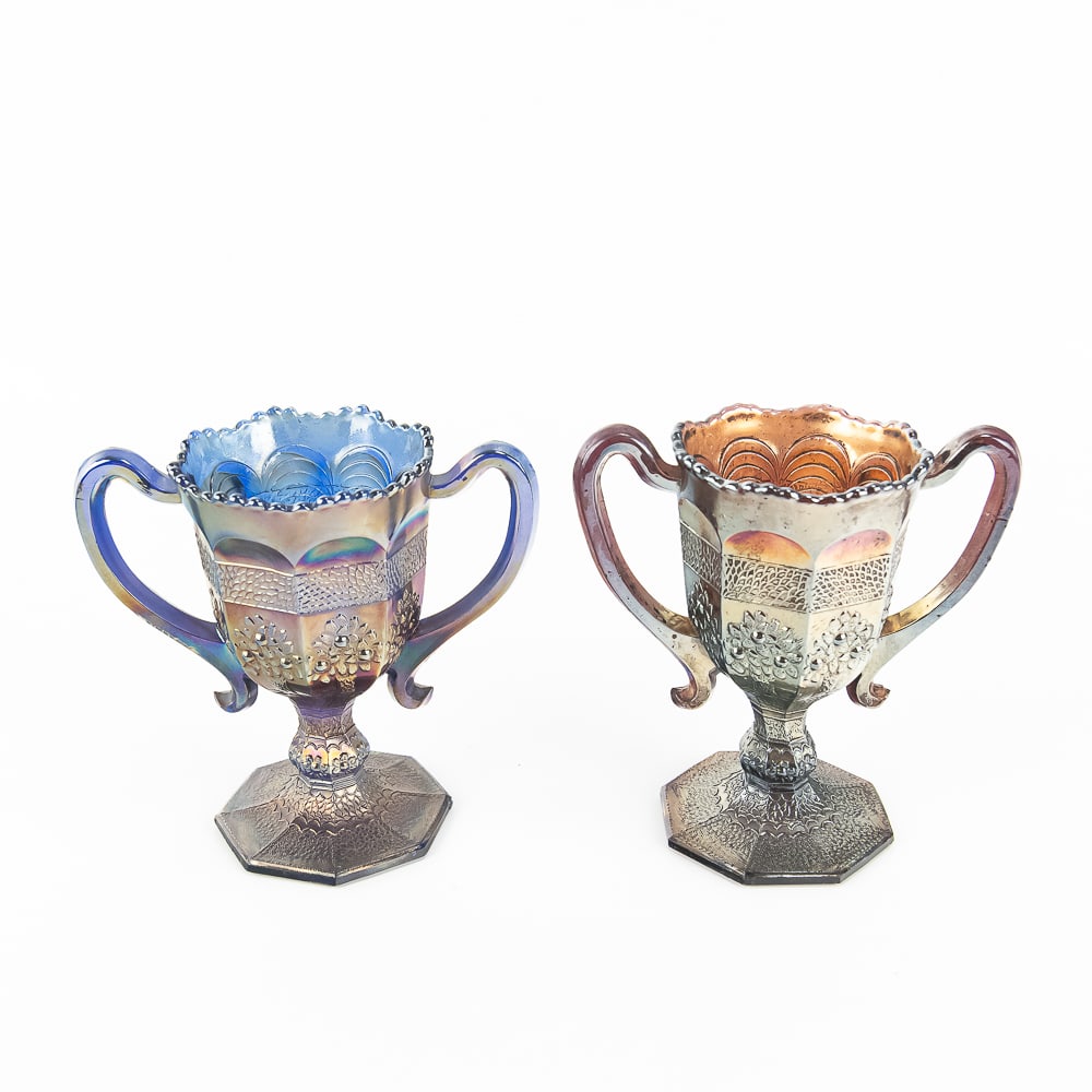 Carnival Fenton Orange Tree Cups: 2-Pc Lot: Includes a blue cup with no issues, and an amethyst cup with a broken tip on the bottom of one handle. See photos to judge condition and bid accordingly.