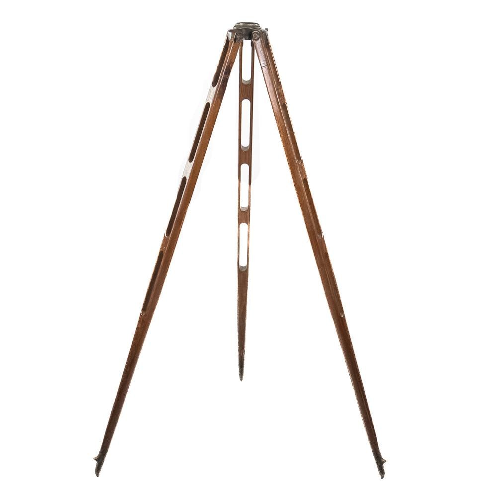 Wooden Surveyor Transit Tripod: An exceptional early 20th-century wooden transit tripod crafted with open-slotted skeleton legs and a threaded brass mounting head with cast wing-nut hardware. Designed for field survey work or