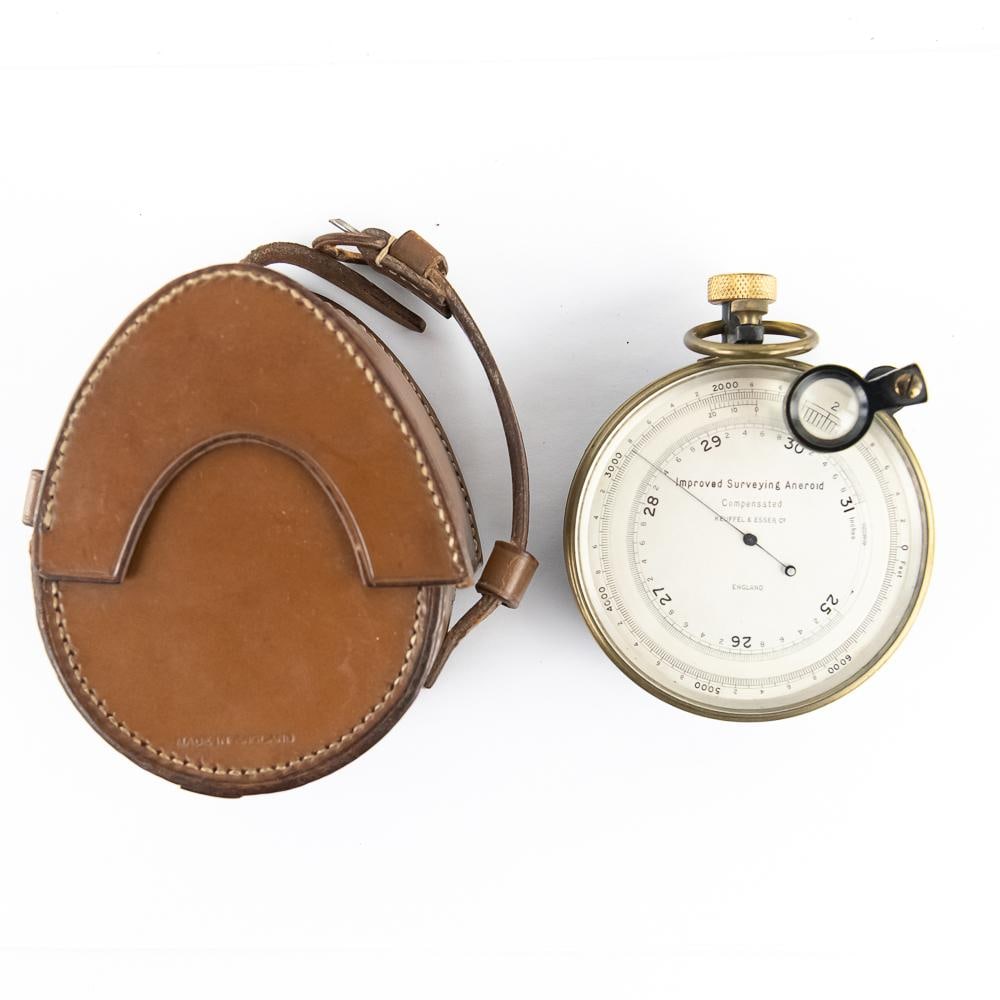 Keuffel & Esser Surveying Aneroid W/Case: This sophisticated "Improved Surveying Aneroid" barometer was manufactured in England for the renowned American firm Keuffel & Esser Co. A vital tool for early 20th-century geologists and engineers,