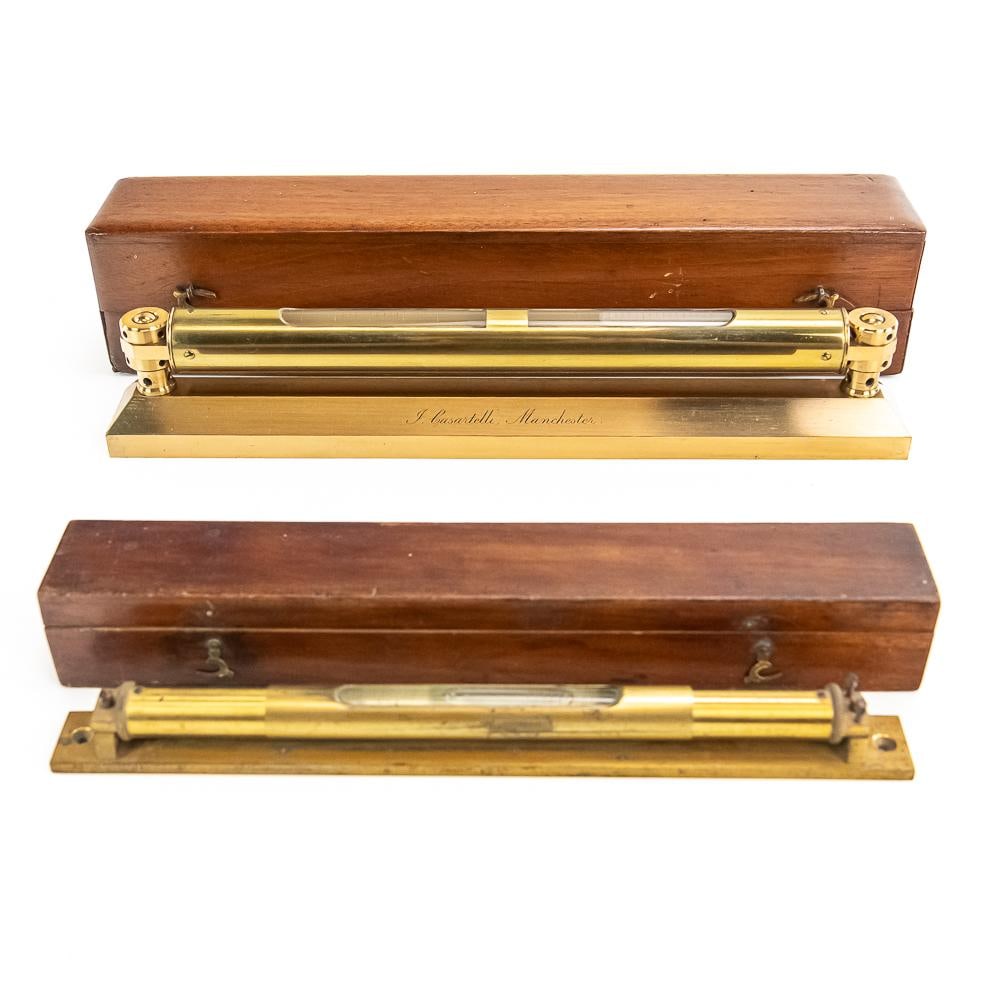 2 Antique Brass Spirit Levels Casartelli: An exceptional pair of 19th-century scientific surveying instruments, featuring precision brass tube spirit levels housing original graduated glass vials and housed in custom velvet-lined and plain
