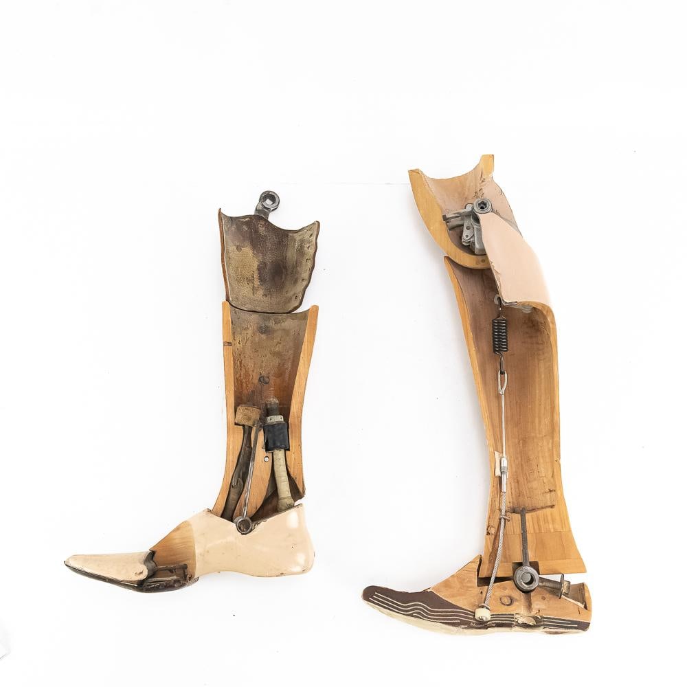Pair of Mid-20th C. Prosthetic Leg Cutaways: This exceptional pair of mid-20th-century articulated artificial lower limbs showcases the advanced mechanical engineering of period orthopedics, featuring a hollowed wooden structural