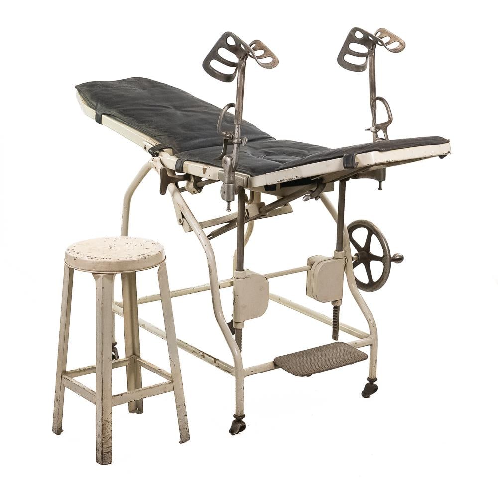 Antique Medical Exam Table & Stool: A remarkable piece of early 20th-century medical history, this articulated examination table and accompanying stool exemplify the heavy-duty industrial craftsmanship of early clinical furniture.