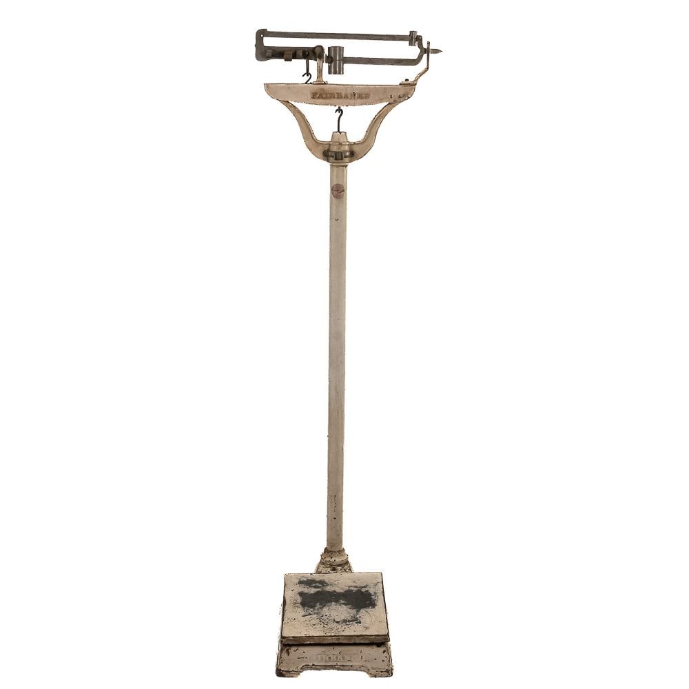 Fairbanks Cast Iron Scale: An exceptional early 20th-century doctor's office or medical balance scale manufactured by Fairbanks, featuring a tall cast iron pillar support, dual notched brass balance beams with poise