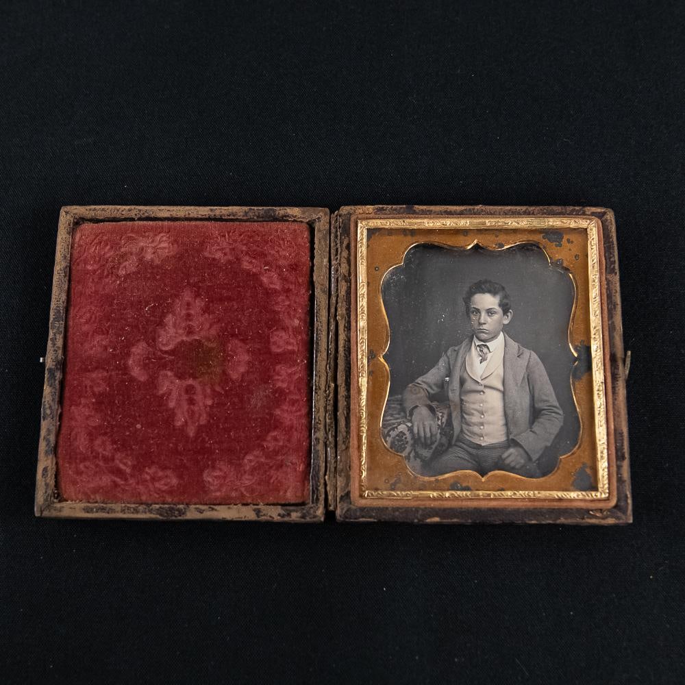 1/6 Plate Cased I.D.'d Daguerreotype: 1/6 plate of a seated well dressed young boy I.D.'d as Tom Lloyd born 1840 son of William & Elizabeth Lloyd (Starr) of Baltimore. The enclosed hand written note states that he died in his early 20's