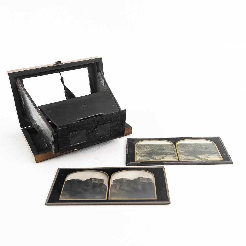 Antique Folding Stereo Viewer w/ Glass Slides (2): Step into 19th-century visual history with this Victorian folding tabletop stereo viewer crafted with fine wood grain veneer and black painted trim, bearing an embossed monogram mark on the folding