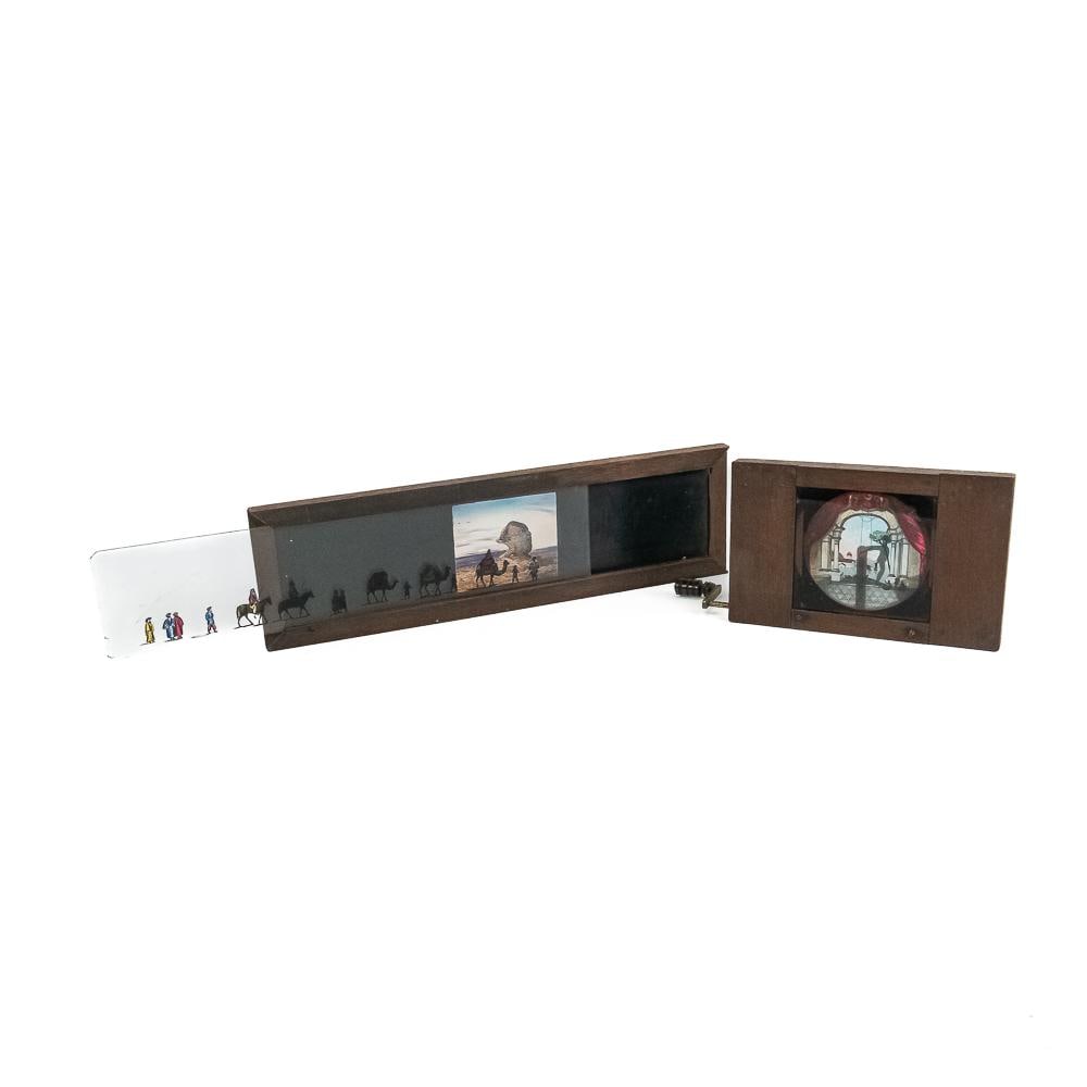2 Victorian Mech. Lantern Slides-Sphinx, Acrobat: Two Victorian 19th-century mechanical hand-painted glass magic lantern slides set in mahogany frames, showcasing early optical projection technology. The lot includes a long horizontal panoramic