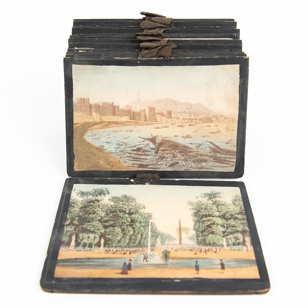 Antique European Polyorama Diorama Slides (12): This exceptional set of 12 19th-century European paper diorama optical slides captures iconic landmark views across Paris, St. Petersburg, Constantinople, Sinope, and Sevastopol. Hand-colored