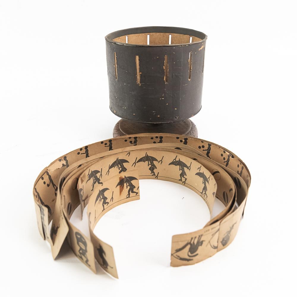 1867 Milton Bradley Zoetrope W/6 Strips: An antique Victorian-era Milton Bradley "Zoetrope" optical animation toy, invented by William E. Lincoln and manufactured in Springfield, Massachusetts. This piece features a black-painted