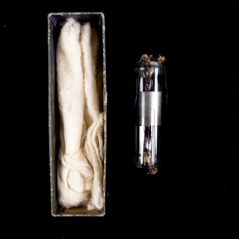 Early Double-Ended Vacuum Tube Apparatus: This early experimental glass vacuum tube is a rare surviving artifact of early 20th-century wireless telegraphy and radio technology. Featuring a central metallic cylinder housed within a hand-blown 