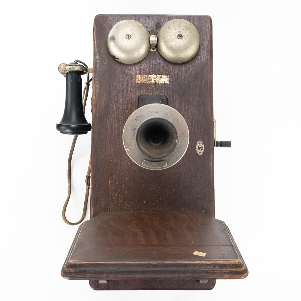 Vintage Oak Western Electric Wall Phone: This antique Western Electric oak wall phone features a classic hand crank, double ringer bells, a mouthpiece labeled "Western Electric Company 350W," a hand receiver, writing shelf, and original wiri