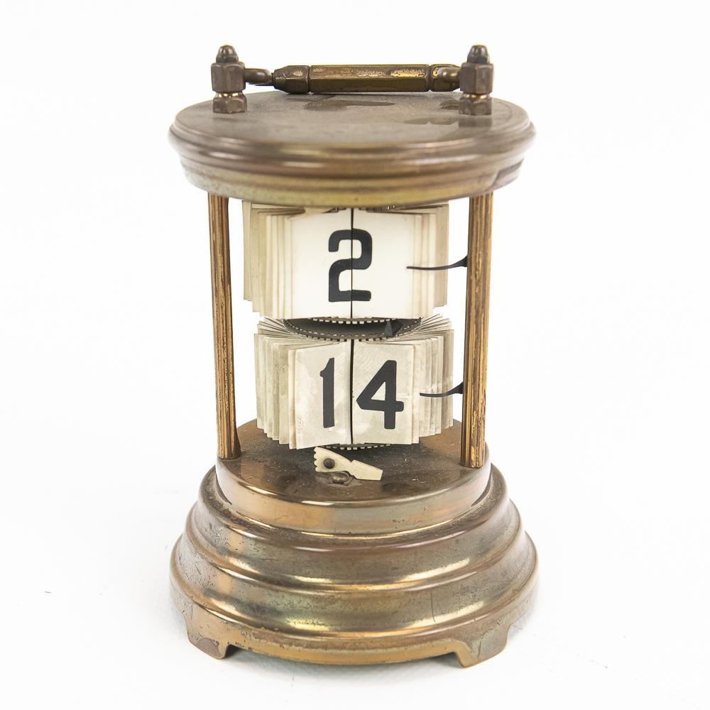 Antique Brass Plato Flip Clock c. 1903: An early landmark in digital horology, this antique Plato carriage-style flip clock features a mechanical digit display enclosed within a cylindrical brass frame topped with a hinged bail handle.