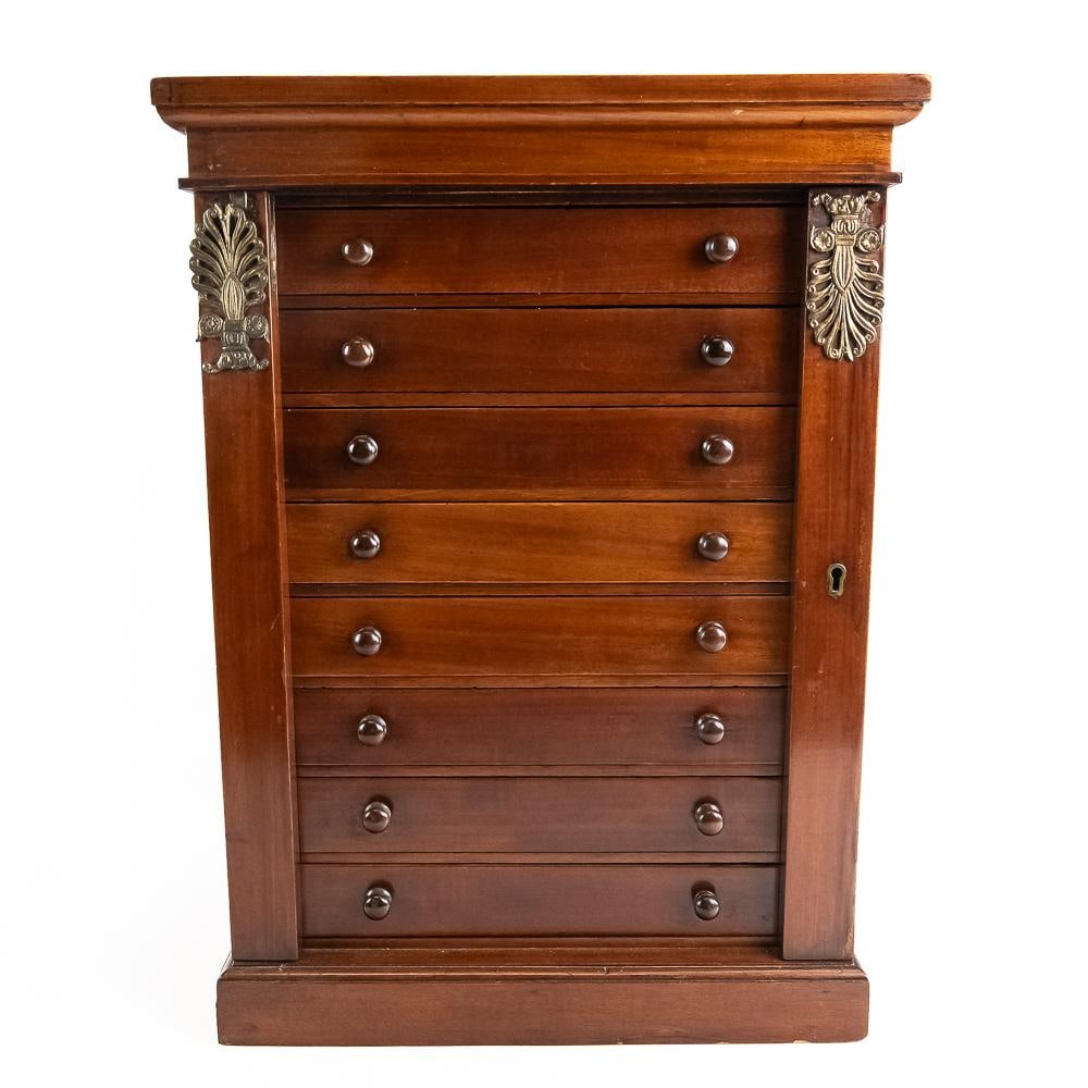 Antique Edwardian Specimen Cabinet 8 Drawers: An elegant Edwardian-era mahogany collector's cabinet featuring eight shallow drawers lined in dark velvet, perfectly designed for housing coins, medals, or mineral specimens. The exterior exhibits a
