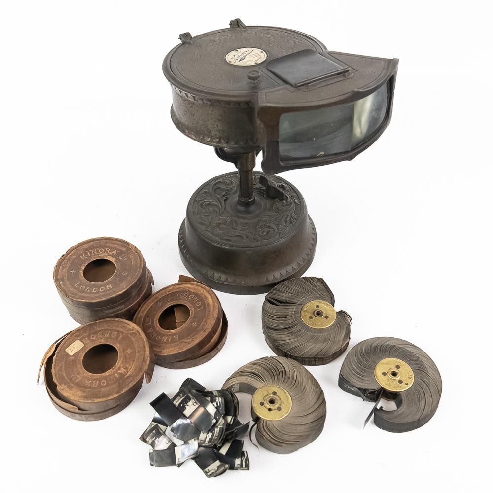 Kinora Motion Picture Machine & 4 Reels: An extraordinary early cinema lot featuring a c. 1900s cast metal table-top Kinora viewer by Kinora Ltd. (B.M. & Biograph Co. Ltd.) of London, England, complete with four total motion picture