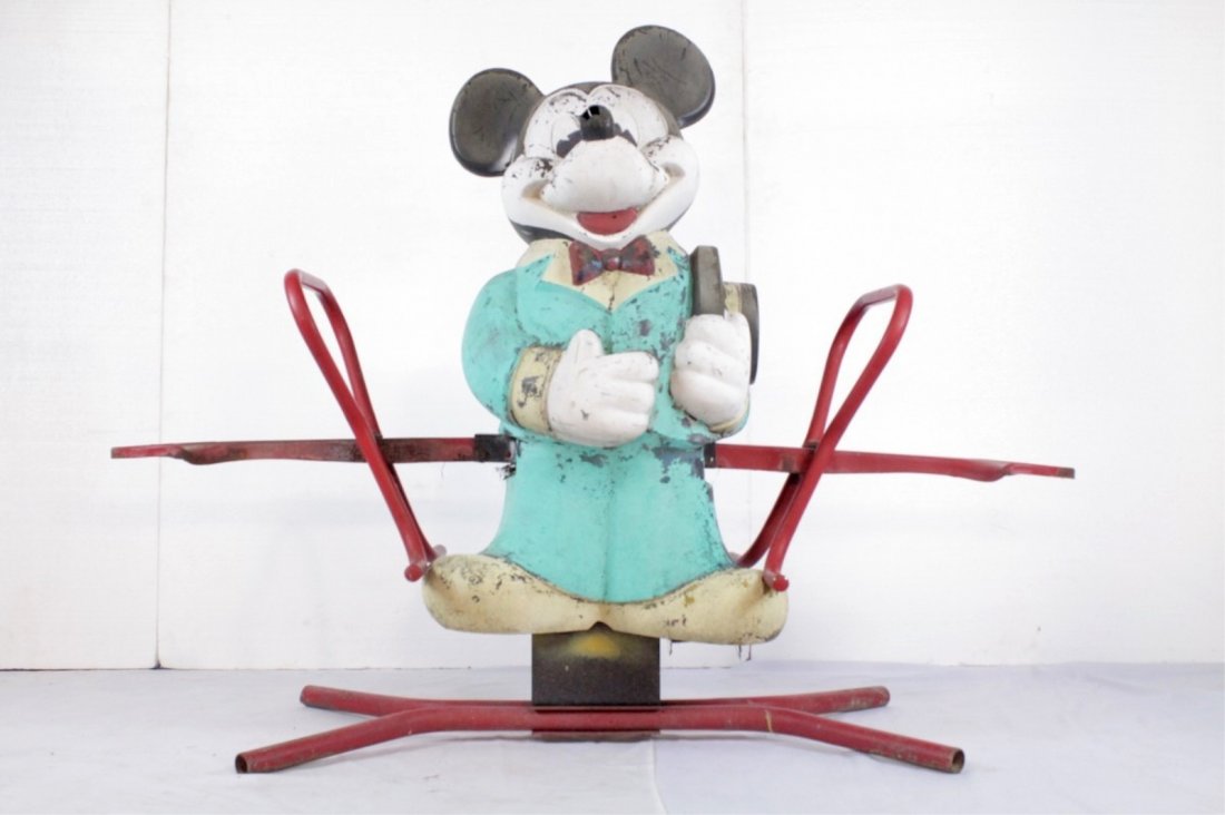 See Saw with Mickey Mouse: Child's teeter totter ride made of a hard rubber Mickey Mouse. Seats are metal and rusted, nose is broken, shows deterioration. Overall fair condition. 61" x 46.5"