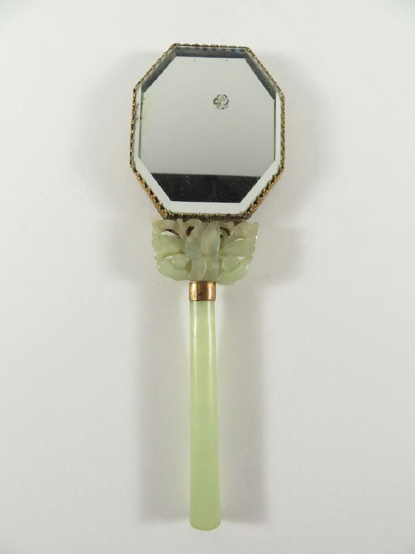 Chinese Jade Precious Stone Hand Mirror: TYPE:Antiques SUB TYPE:Mirror REGION:Asia SUB REGION:China MEDIUM:Jade SGD/UNS: TITLE:Chinese Jade Precious Stone Hand Mirror CATALOG NOTES:A Chinese hand mirror with jade handle and medallion. Also h