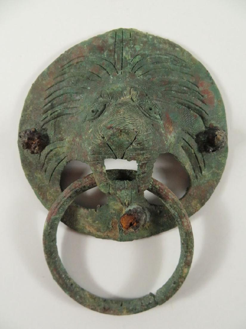 Antique Roman Bronze Lion Door Handle: TYPE:Antiques SUB TYPE:Sculpture REGION:Europe SUB REGION:Roman MEDIUM:Bronze SGD/UNS: TITLE:Antique Roman Bronze Lion Door Handle CATALOG NOTES:An Antique Roman bronze lion's head ringed door handle.