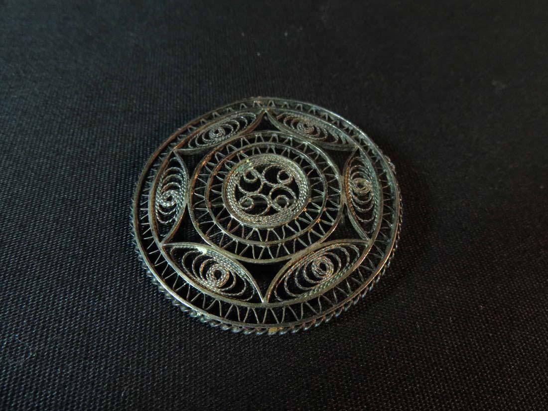 Pin Sterling ? Round Etruscan ? Revival Filigree: TYPE:Antiques SUB TYPE:Jewelry REGION: SUB REGION: MEDIUM: SGD/UNS: TITLE:Pin Sterling ? Round Etruscan ? Revival Filigree CATALOG NOTES: INSIDE HEIGHT: INSIDE WIDTH: OUTSIDE HEIGHT:1.625 OUTSIDE WIDT