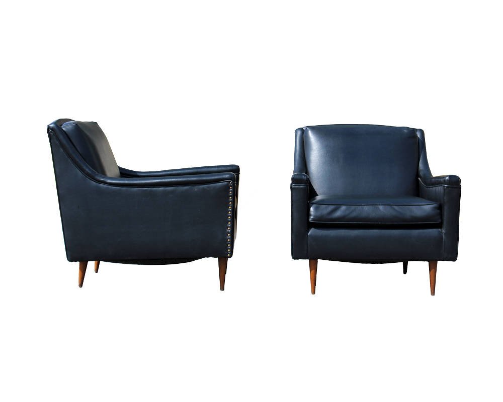 Pair of Black Lounge Armchairs Mccobb Baughman Era: For your consideration is a fantastic pair of lounge chairs, upholstered in a studded, black vinyl with wooden legs. In excellent condition. Attributed to either Baughman or Mccobb. The dimensions are