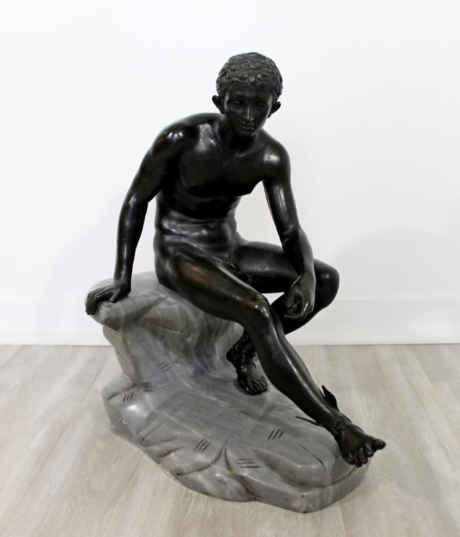 Hermes Greek God Nude Bronze Table Sculpture Marble: This large sculpture of Hermes is after the BC original from the villa of Papri, Herculaneum. The messenger of the gods is seated on a rocky outcropping wearing winged sandals. This piece measures 19"