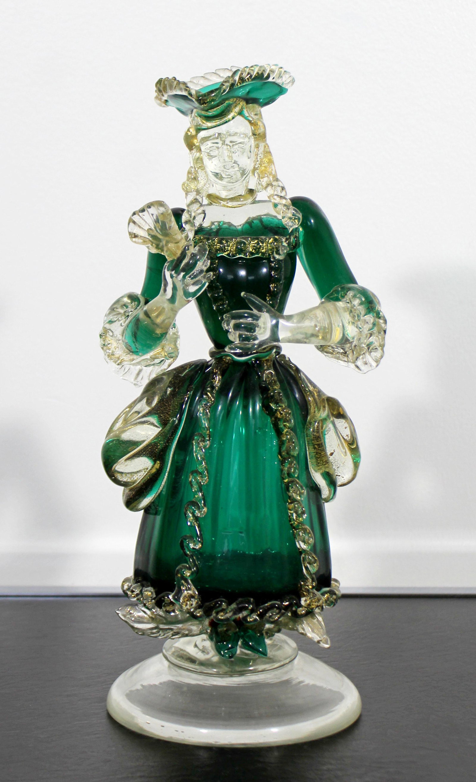 Green Gold Fleck Murano Venetian Woman Table Sculpture: For your consideration is a phenomenal, green and gold flecked Murano glass table sculpture, of a Venetian woman, in the style of Barovier Toso and Seguso, circa the 1960s. In excellent condition. The