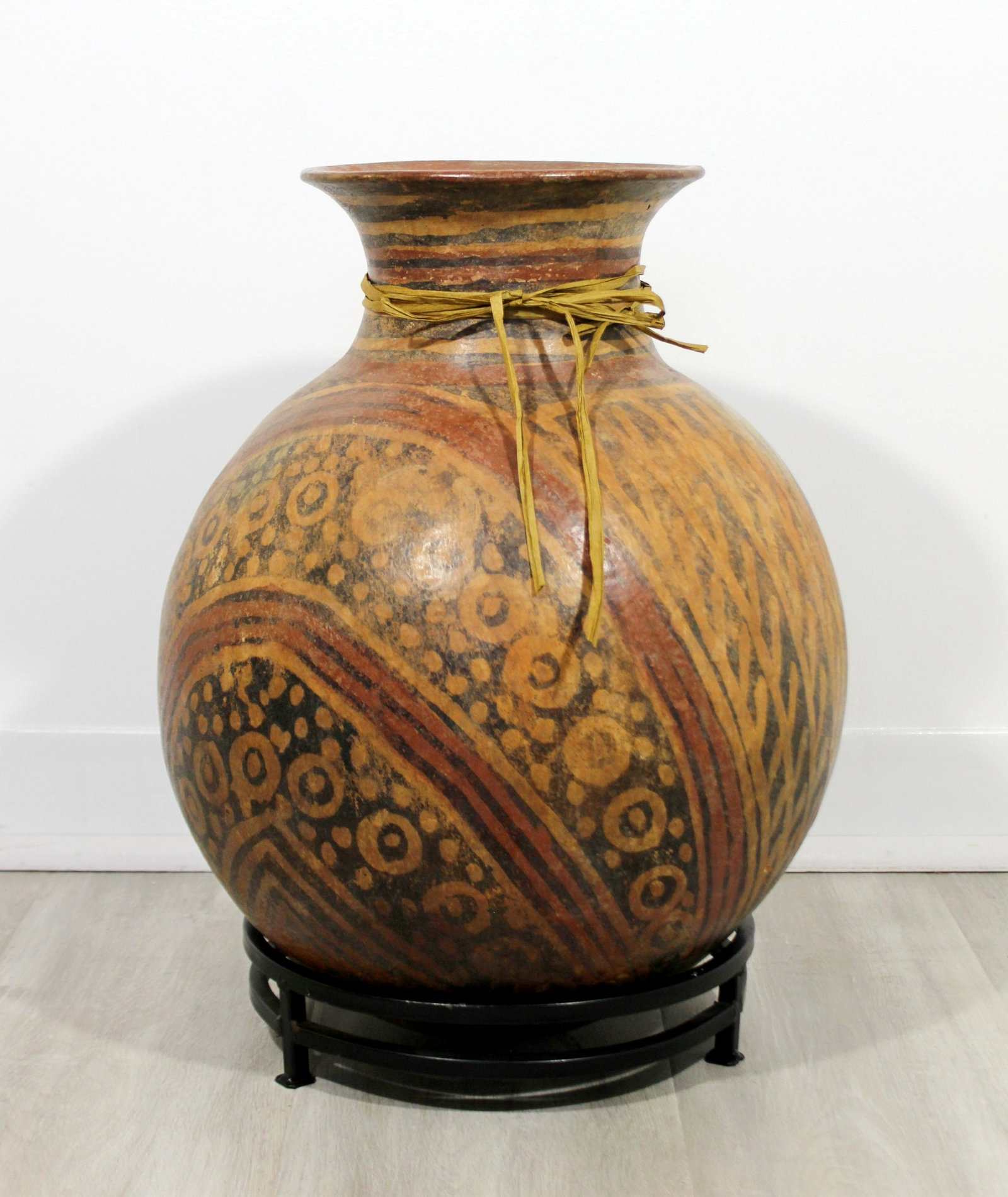 Terracotta Poly-Chrome Ceramic Vessel Vase Floor: For your consideration is a large, primitive, terracotta poly-chrome ceramic vessel floor sculpture on a stand. In excellent condition. The dimensions are 12" Dia x 18" H.