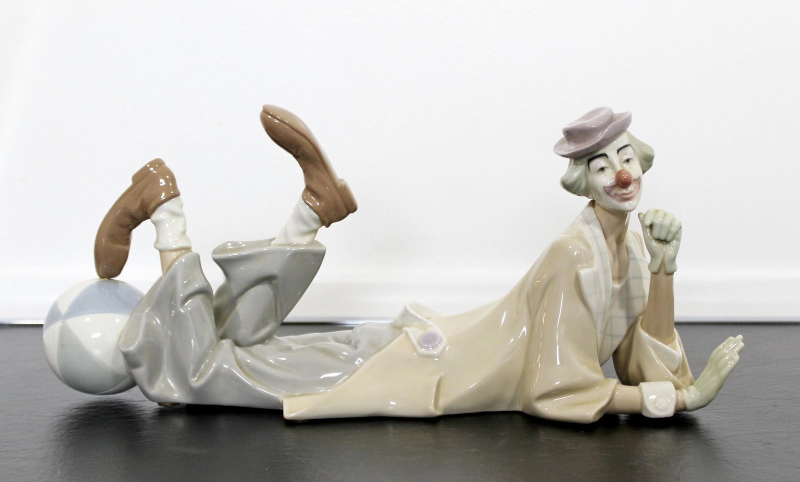Porcelain Tired Clown Table Sculpture Signed Lladro: For your consideration is a whimsical, porcelain table sculpture, entitled "Payaso Acostado," stamped Lladro, hand made in Spain, circa the 1970s. In excellent condition. The dimensions are 14.5" W x 